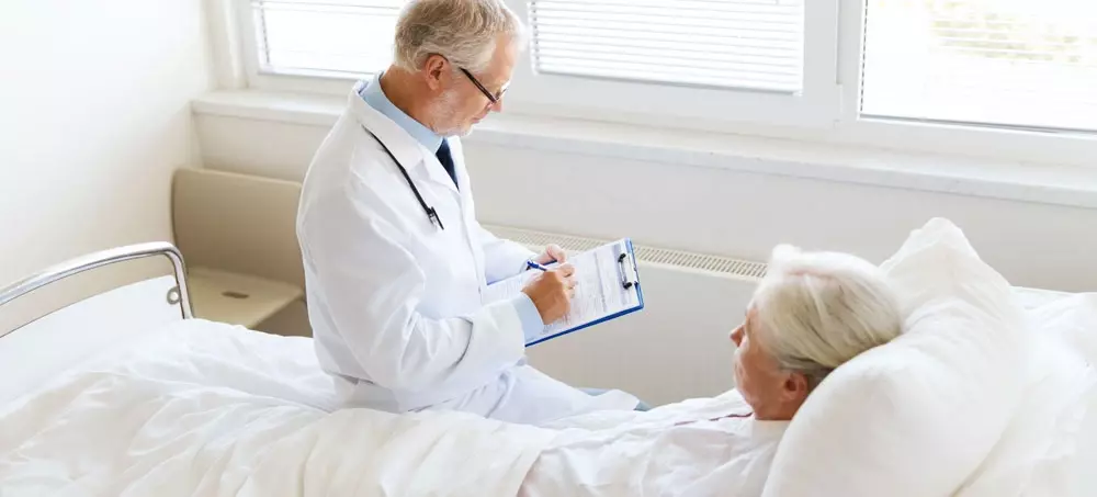 /article/senior-woman-doctor-writing-clipboard-hospital-ward.webp